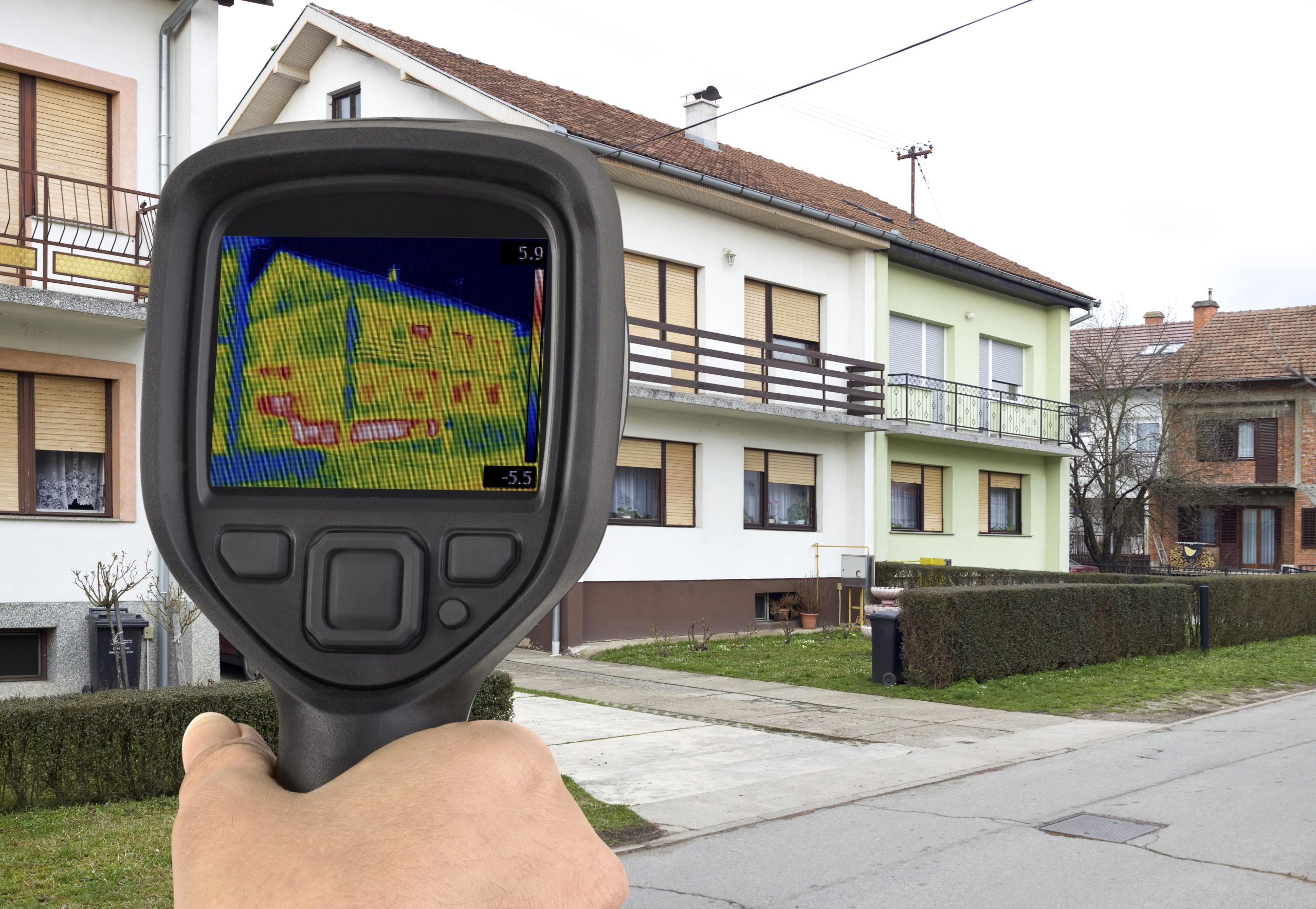 thermographic camera pointed at a house